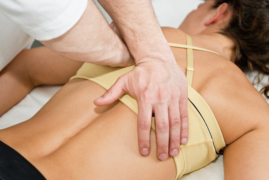 blog picture of lady laying down while chiropractor works on her back