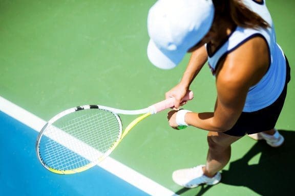 blog picture of female tennis player about to serve