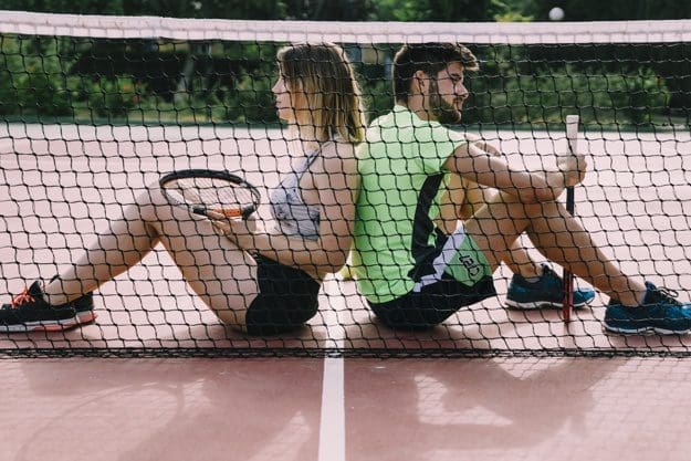 tennis elbow players sitting at the net